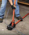 Worker using Workhorse Rebar Cutter And Bender For 5/8 Inch Steel, Built Tough With Shear Cut Blades, on gray concrete floor
