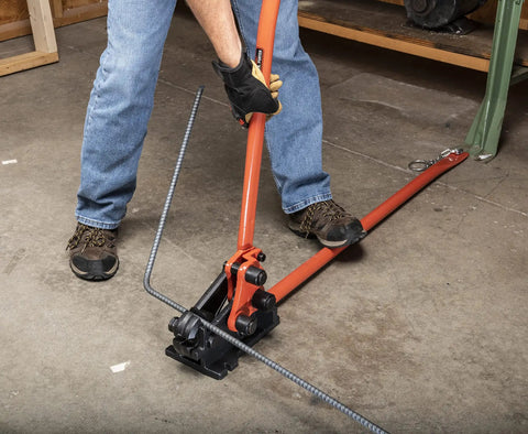 Worker using Workhorse Rebar Cutter And Bender For 5/8 Inch Steel, Built Tough With Shear Cut Blades, on gray concrete floor