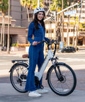 Woman on Cityscape 2.0 Electric Commuter Bike For Adults With 468Wh Removable Battery 26 Inch Wheels Up To 50 Miles in city