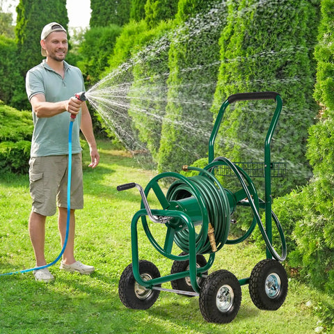 Man watering lawn with heavy duty garden hose reel cart with four wheels holds up to 300 feet of five eighths inch hose