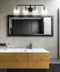 Oil Rubbed Bronze Farmhouse 36 Inch LED Vanity Wall Sconce with Clear Seeded Glass Shade above bathroom sink