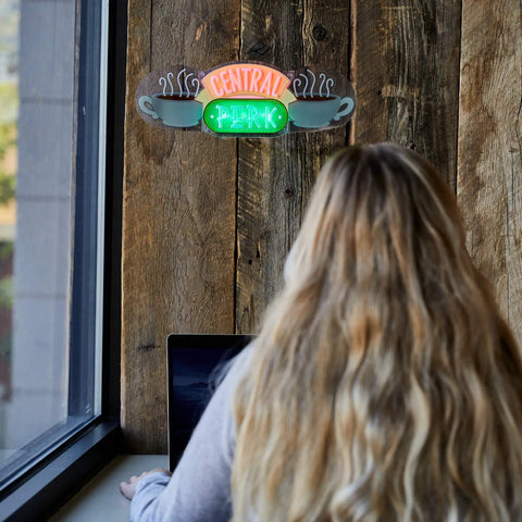 Person at desk under Central Perk LED Neon Light Wall Mounted Officially Licensed Friends Show Decor Neon Sign For Living Room