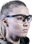 Person wearing clear lens safety glasses with side shields, anti fog, anti scratch, anti glare protective eyewear for men and women.