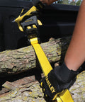 Person using Heavy Duty Ratchet Tie Down Straps 1.5 Inch by 16 Foot, 1100 Lb Safe Working Load to secure logs