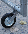 Heavy Duty Gate Wheel Kit For Swing Gates, 6-Inch Wheel Fits 1-5/8 To 2-Inch Gate Frames, Durable Farm Gate Wheel For Chain Link Fences, Stops Gate Dragging, Black Steel With Rubber Tire, Easy Install attached to metal gate on concrete surface