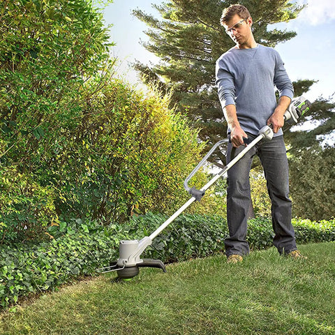 Man using Two Pack Ergonomic Trimmer Handle Set With Bracket Clamp For Aluminum Lawn Trimmers to trim grass in garden
