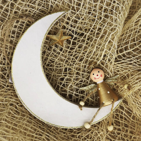Decorative crescent moon ornament with a star and doll in craft setting