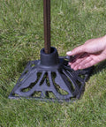 Heavy Duty Cast Iron Torch Stand Built Like A Tank For Outdoor Lighting, freestanding base held in hand, on grass