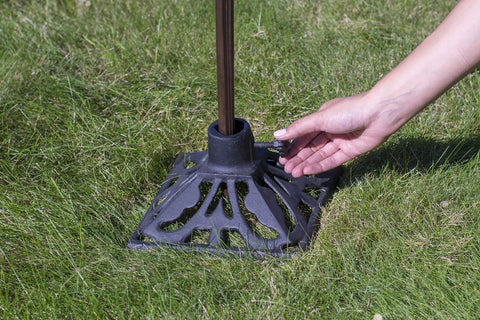 Heavy Duty Cast Iron Torch Stand Built Like A Tank For Outdoor Lighting, freestanding base held in hand, on grass
