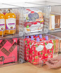 Four Pack Large Clear Stackable Storage Drawers With Smooth Pull Out Slides And Grippy Silicone Pads For Super Neat Closets That Keep Your Belongings Squared Away Daily with juice bottles and snacks.