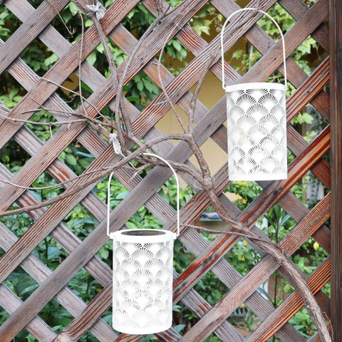 Solar Powered Outdoor Lanterns Waterproof White Table Lanterns Set Of 2 for Outdoor Use Hanging LED Lights against wooden trellis
