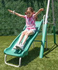 Child sliding down 5ft wave slide of Outdoor Backyard Playset With 2 Swings, Glide Ride, Trapeze And 5Ft Wave Slide, Vinyl Coated Chains