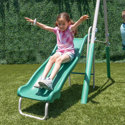 Child sliding down 5ft wave slide of Outdoor Backyard Playset With 2 Swings, Glide Ride, Trapeze And 5Ft Wave Slide, Vinyl Coated Chains