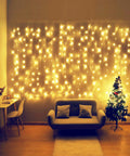 Curtain Icicle Lights 13ft By 6.5ft Warm White Low Voltage 30V with 20 Strings creating cozy indoor decor setup