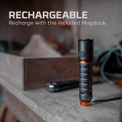 Torchy 2K Rechargeable Pocket Flashlight With 2000 Lumens in a workshop, showing magnetic base and USB recharging setup.
