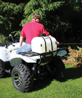 Person using 9 Gallon UTV And ATV Spot Sprayer With Everflo 1.0 GPM Diaphragm Pump mounted on ATV to spray trees.