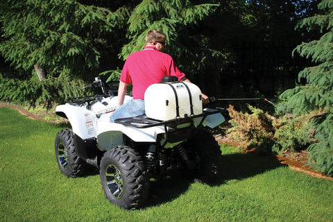 Person using 9 Gallon UTV And ATV Spot Sprayer With Everflo 1.0 GPM Diaphragm Pump mounted on ATV to spray trees.