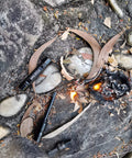 2 Pack Ferro Rod Fire Starter With Replaceable Flint for emergency survival on rocky ground with fire sparks showing usability
