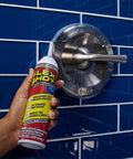 Rubber Adhesive Sealant Caulk Eight Ounce Clear Flexible Bonding Sealant bottle near a metal shower fixture on blue tiles