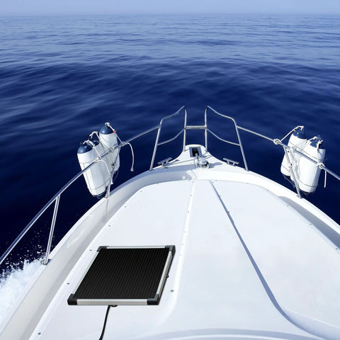 Heavy Duty Five Watt Solar Battery Trickle Charger With Overcharge Guard mounted on a boat deck overlooking the ocean.