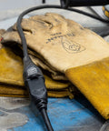 Beefed-Up Heavy Duty Outdoor Extension Cord 15 Ft 16 Gauge 3 Prong Grounded, on workbench next to gloves