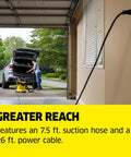 Man using WD 5 P Shop Vacuum 6.6 Gal Wet Dry Vacuum Cleaner With 33 Ft Reach in garage with hose and power cable visible