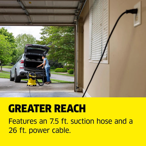 Man using WD 5 P Shop Vacuum 6.6 Gal Wet Dry Vacuum Cleaner With 33 Ft Reach in garage with hose and power cable visible