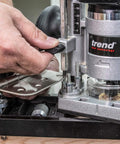 Close-up of a Trend router aligning with an All-In-One Adjustable Door Hinge Jig Installation Kit For 2 Ft 6 In To 9 Ft Doors