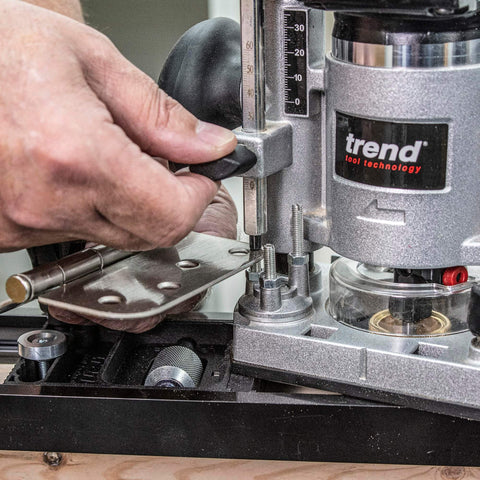 Close-up of a Trend router aligning with an All-In-One Adjustable Door Hinge Jig Installation Kit For 2 Ft 6 In To 9 Ft Doors