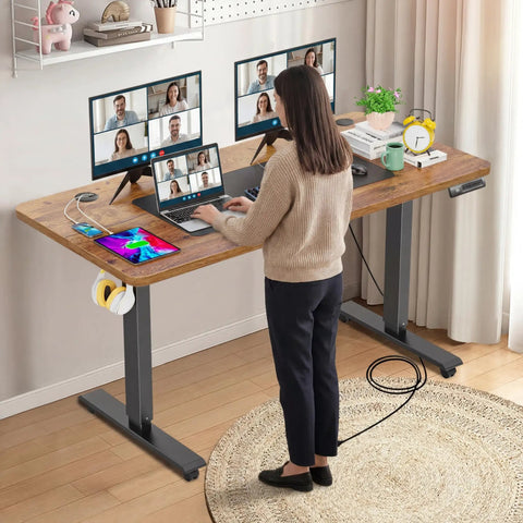 Farexon Electric Standing Desk Adjustable Height Black Brown Wood Grain Surface With Power Outlets, Wheels, And Mouse Pad for dual monitor setup in home office.