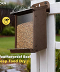 Weatherproof Metal Wall Mounted Bird Feeder With Heavy Duty Roof And Detachable Easy Clean System installed outdoors on fence