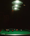 Three Light Pulley Pendant Island Light With Industrial Vintage Rustic Vibe over pool table in dimly lit game room