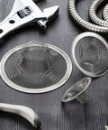 Stainless Steel Sink Strainer 12 Pack Heavy Duty Mesh Sieve Catches Food Gunk And Hair No Sweat Drain Catcher With Rust Proof Build That Nails Kitchen Cleanup For All Basins arranged with tools on a wooden surface.