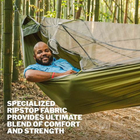 Person relaxing in JungleNest Pacific Hammock with Extended 10 Foot Length Structural Ridgeline and integrated bug net