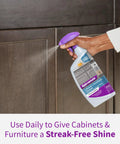 Cabinet And Furniture Cleaner That Wipes Away Dirt Grime And Grease Buildup Cleans And Shines With A Streak Free Finish No Fuss No Mess For Indoor Cabinets And Furniture On Hardwood Laminates And Finished Wood PH Balanced 24 Ounce being sprayed on wooden cabinet
