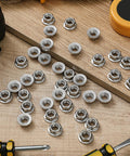 Killer Grade M6 Serrated Flange Nuts 100 Pack Built Hella Tough From Rust Free 304 Stainless Steel Heavy Duty Hexagon Bolts on wood surface.