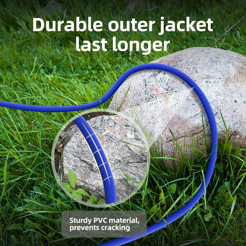 Heavy Duty 12 Gauge Outdoor Extension Cord 100 Ft Long Waterproof Power Cable laid on grass with a durable PVC jacket near a rock.