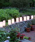 White Plastic Luminaria Lanterns Pack Of 100 With Printed Design For Indoor And Outdoor Use All Weather Ready Pathway Lighting 5.75 Inch Long By 3.5 Inch Wide By 10 Inch Tall Battery Operated Light Not Included illuminating a garden path