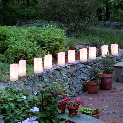 White Plastic Luminaria Lanterns Pack Of 100 With Printed Design For Indoor And Outdoor Use All Weather Ready Pathway Lighting 5.75 Inch Long By 3.5 Inch Wide By 10 Inch Tall Battery Operated Light Not Included illuminating a garden path