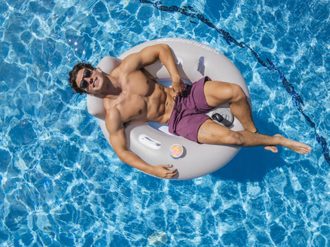 Person relaxing in Motorized Pool Tube Float For Adults Pro 3.0 With 66W Motor Joystick Steering Phone Holder And Cup Holder Blue Finish