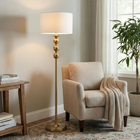 Riley 60 Inch Floor Lamp With Drum Shade In Gold Brass Finish For Living Room Or Bedroom Modern Standing Lamp with beige chair