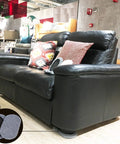 Black leather sofa on wooden floor with 8-Piece Furniture Moving Kit For All Floor Types 2-In-1 Reusable Sliders visible underneath