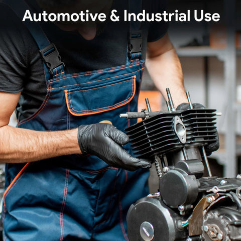 Side view of mechanic wearing FifthPulse black nitrile gloves, large, handling an engine cylinder head.