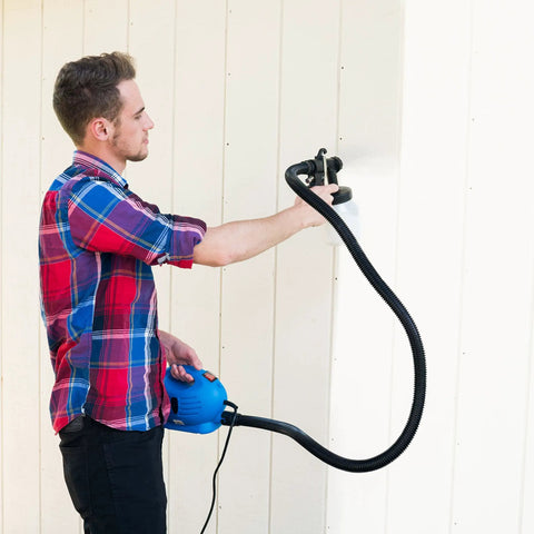 Man using One Touch Paint Sprayer For Home DIY Projects Cut Time And Paint Costs In Half With This Easy Blue Finishing Tool For Walls Cabinets Fences.