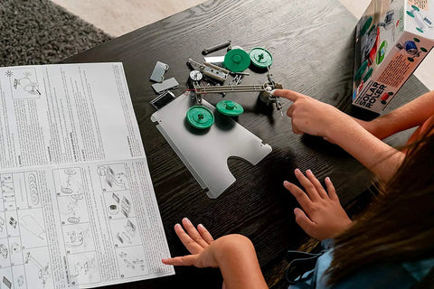 Green Solar Rover Kit For Kids DIY STEAM Science Project To Build Your Own Solar Powered Rover From A Recycled Can Ages Five And Up Hands On Learning Toy For Boys And Girls, parts laid out on table