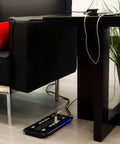 Turn One Outlet Into Twelve With Tethered USB Ports Surge Protector, 8 Ft Cord, Flat Plug, 4320 Joules, Power Filter, Circuit Breaker, UL Listed, Black, Extra Wide Spaced Outlets, Warranty Included installed next to a couch and table