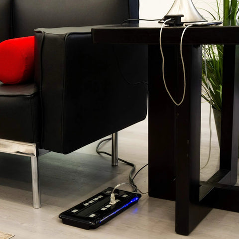 Turn One Outlet Into Twelve With Tethered USB Ports Surge Protector, 8 Ft Cord, Flat Plug, 4320 Joules, Power Filter, Circuit Breaker, UL Listed, Black, Extra Wide Spaced Outlets, Warranty Included installed next to a couch and table