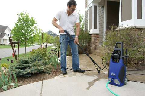 Man using Beast Mode Portable Pressure Washer 1900 PSI 1.51 GPM 14 Amp With Bayonet Attachments for cleaning driveway