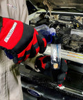 Mechanic using combustion leak detector for engine block leaks and blown head gasket tests plastic and rubber test kit