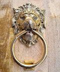 Vintage Brass Lion Door Knocker And Gate Pull With Solid Brass Finish Embossed Lion Mouth Design Traditional Door Accessory For Home Decor Entryway Accent 7 X 4 X 2 Inch close-up showing intricate details against wooden background.